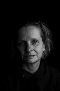 A professional headshot portrait of a visionary filmmaker in a dark-themed cinematic style.