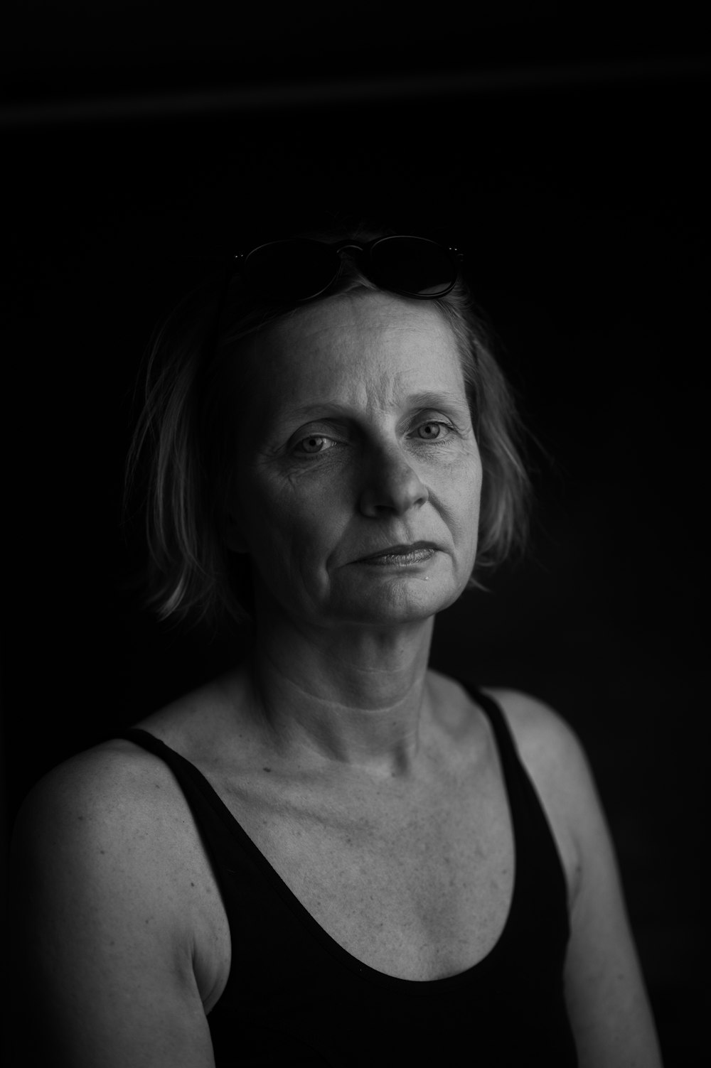 woman in tank top wearing sunglasses