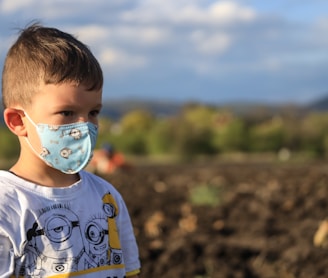 boy in white and blue crew neck shirt with white and blue pacifier