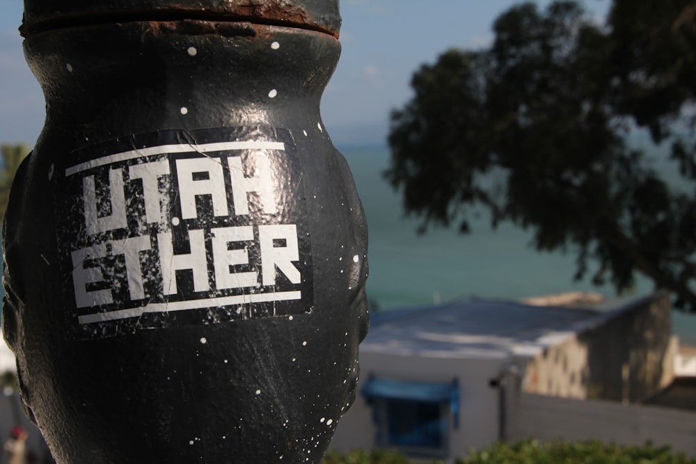 a black fire hydrant with a sticker on it