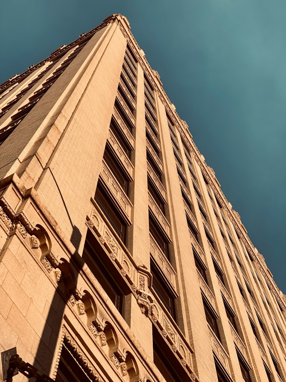 brown concrete building under blue sky during daytime