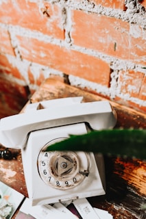 A close-up photo of vintage collectible phone cards arranged neatly on a wooden surface.