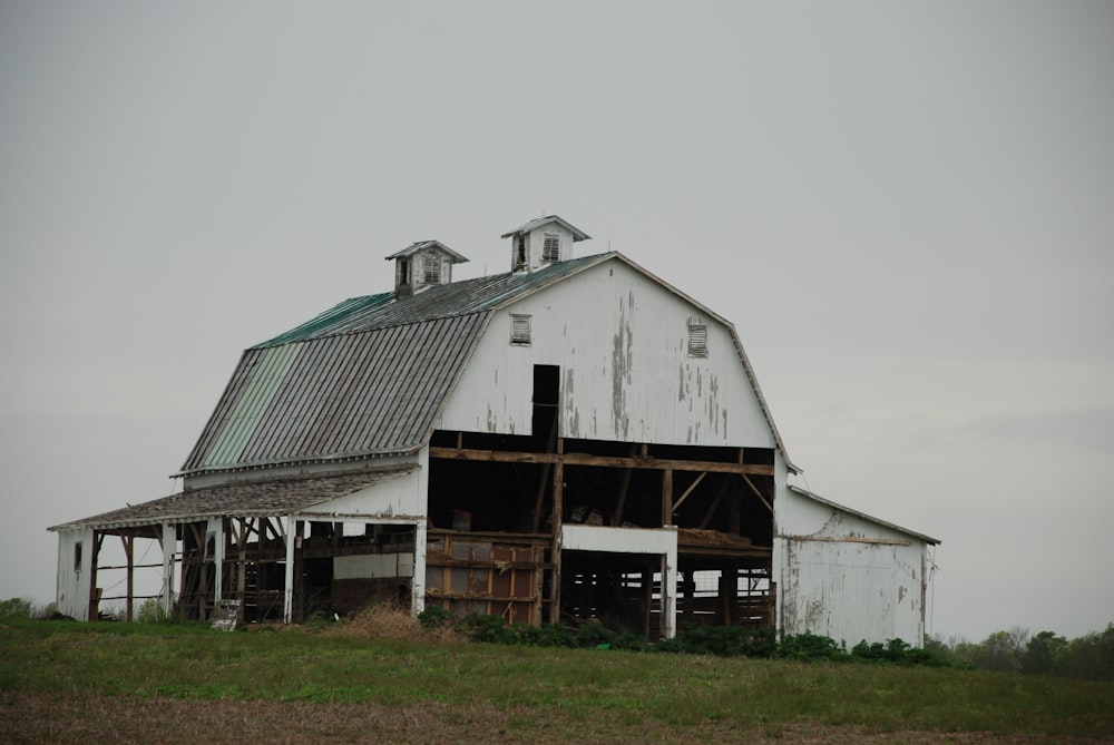 brown wooden barn under white sky during daytime