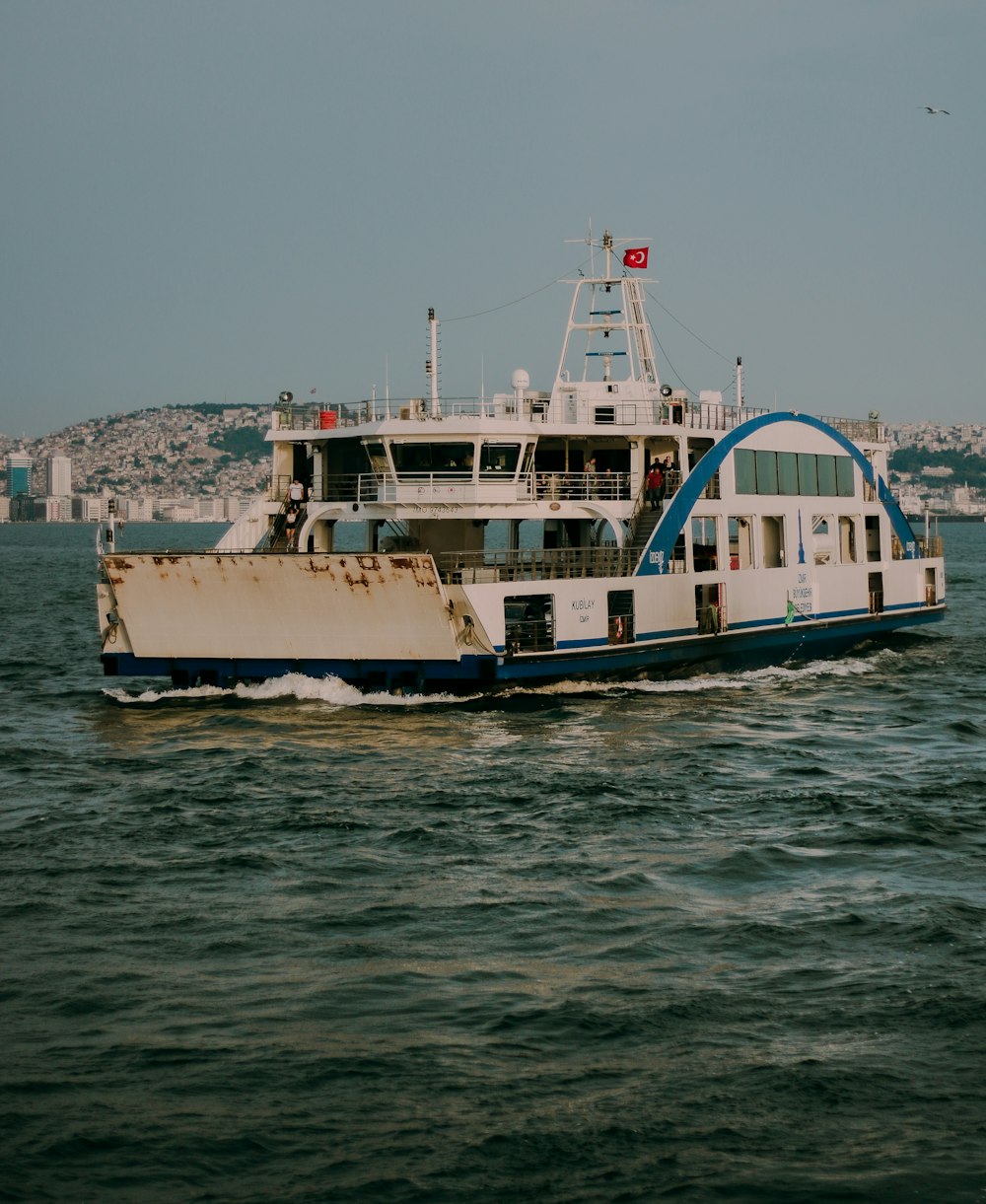 white and blue ship on sea during daytime