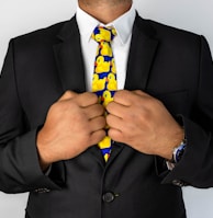 man in black suit jacket with blue necktie