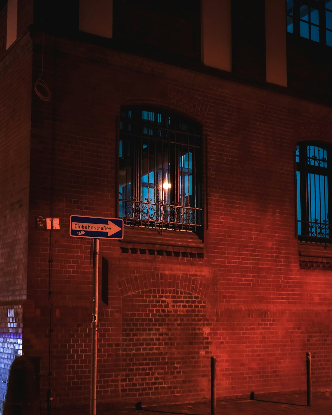 brown brick building with red and white signage