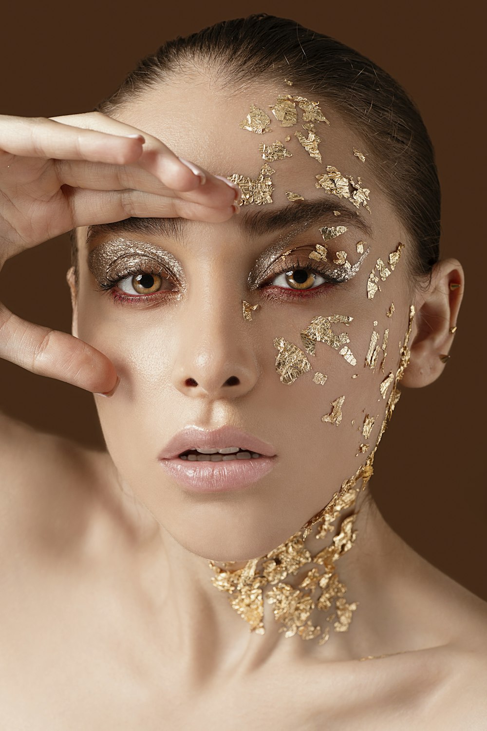 woman with gold floral face paint
