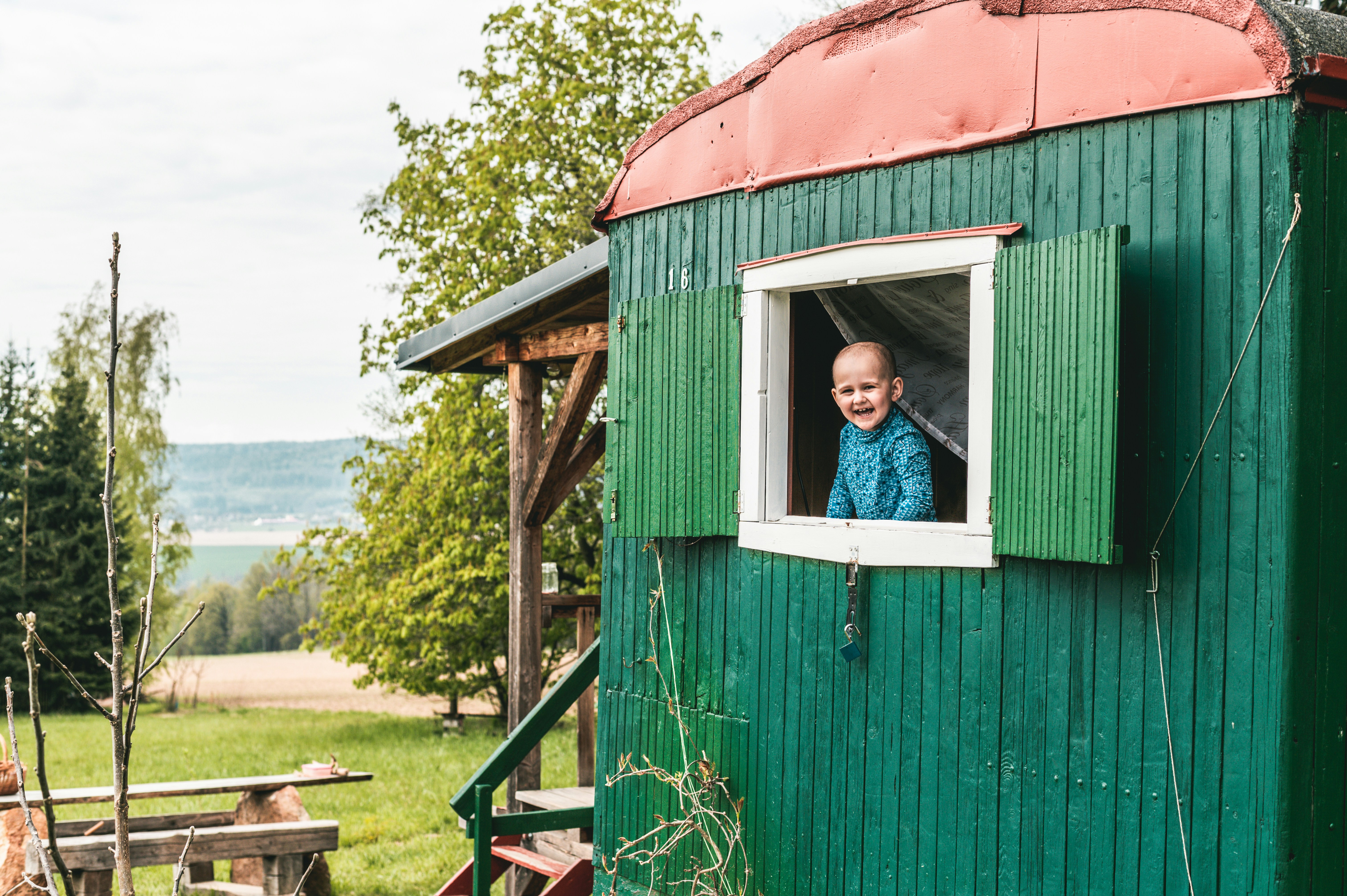 Green cabin caravan and smiling boy