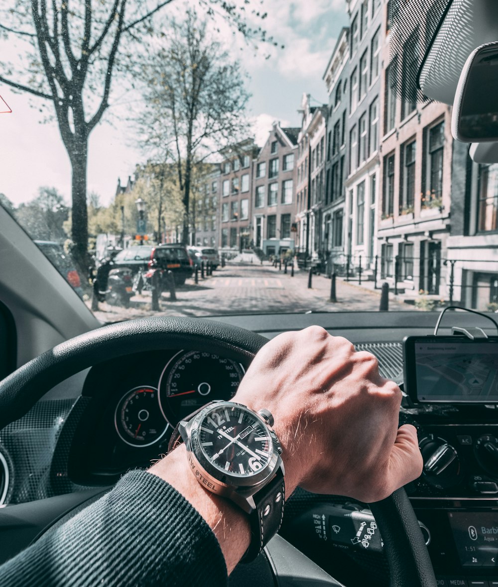 person driving car on road during daytime