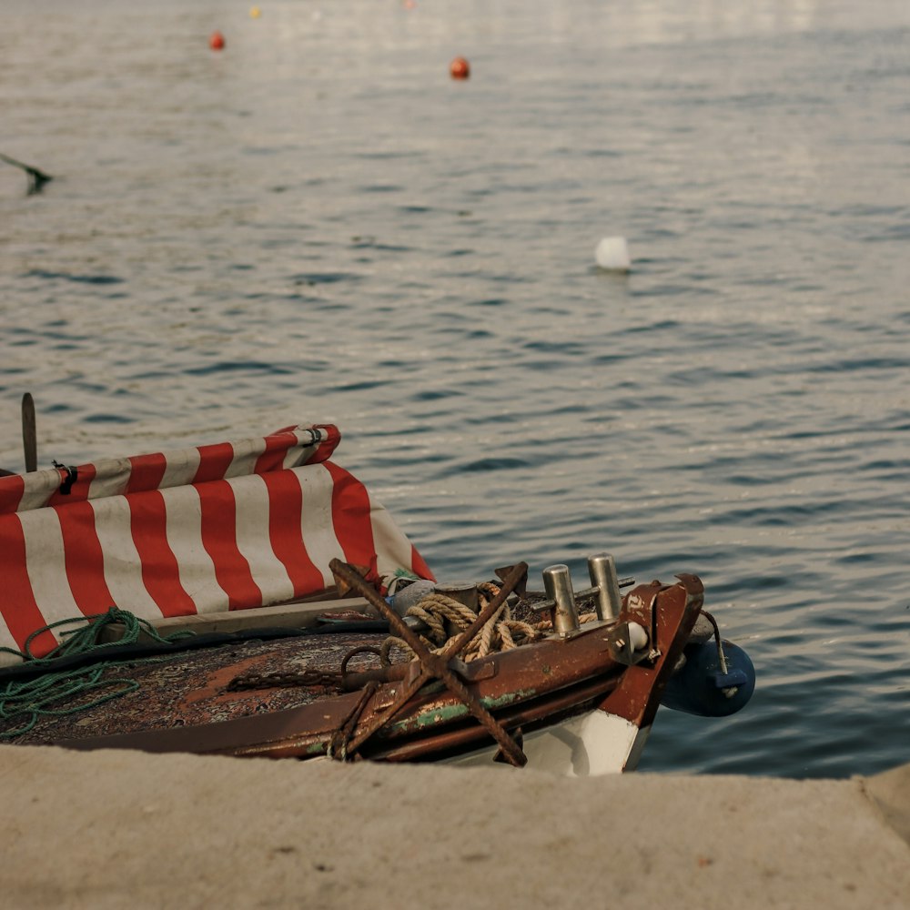 brown wooden boat on beach shore during daytime