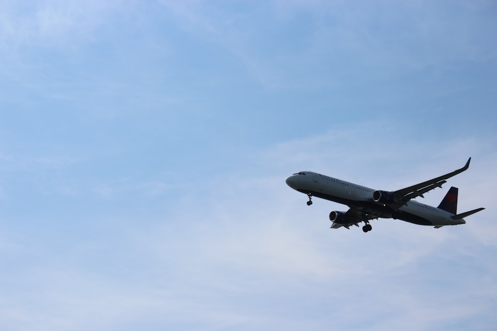 white airplane flying in the sky during daytime