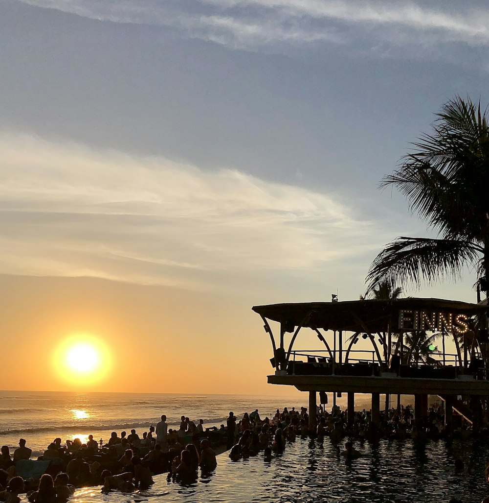 people on beach during sunset