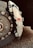Close-up view of a high-performance vehicle brake system featuring a ventilated disc and a caliper with an RS logo. The disc is metallic with visible bolts, while the caliper appears sleek and robust.