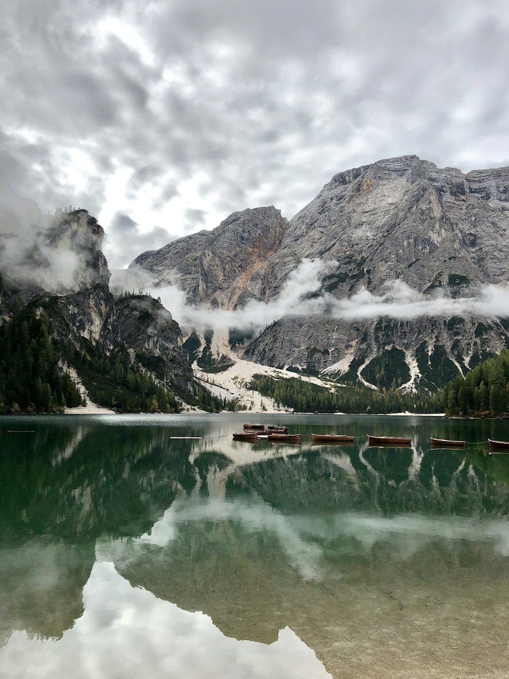 lake near snow covered mountain during daytime