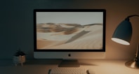 silver imac on brown wooden table