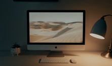 silver imac on brown wooden table