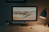 silver imac on brown wooden table