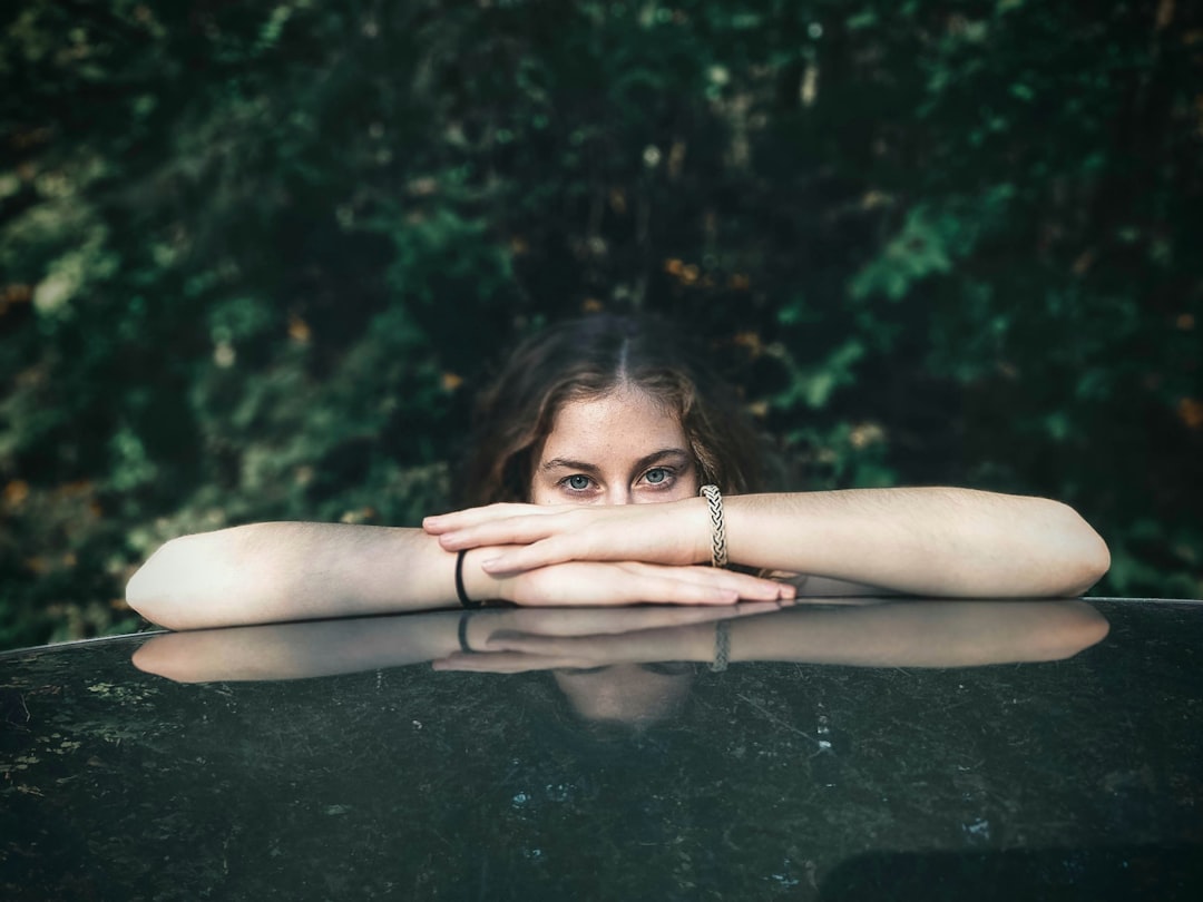 woman lying on black concrete floor