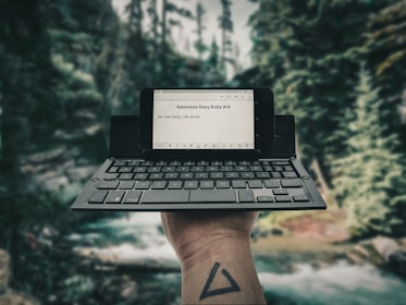 person holding black laptop computer