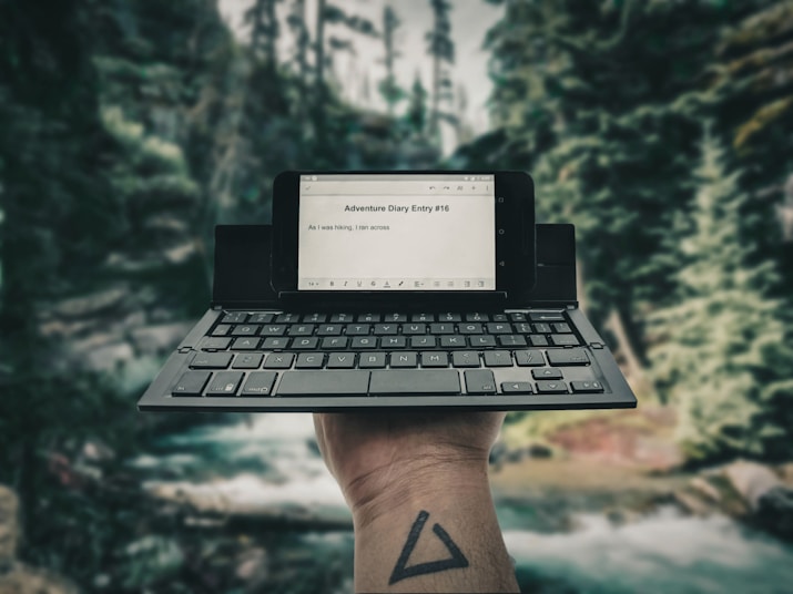 person holding black laptop computer