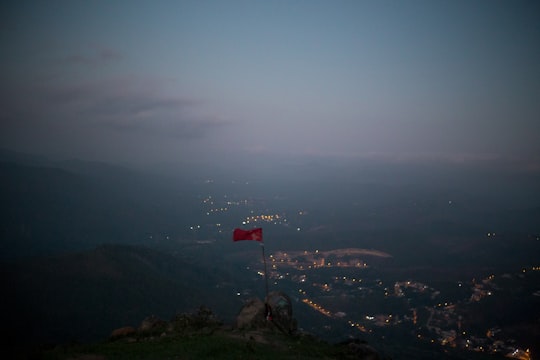 red and white flag on top of mountain during daytime in Mairiporã Brasil
