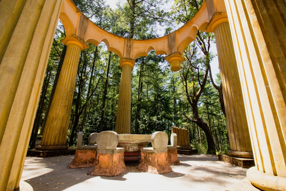 brown wooden bench near trees during daytime