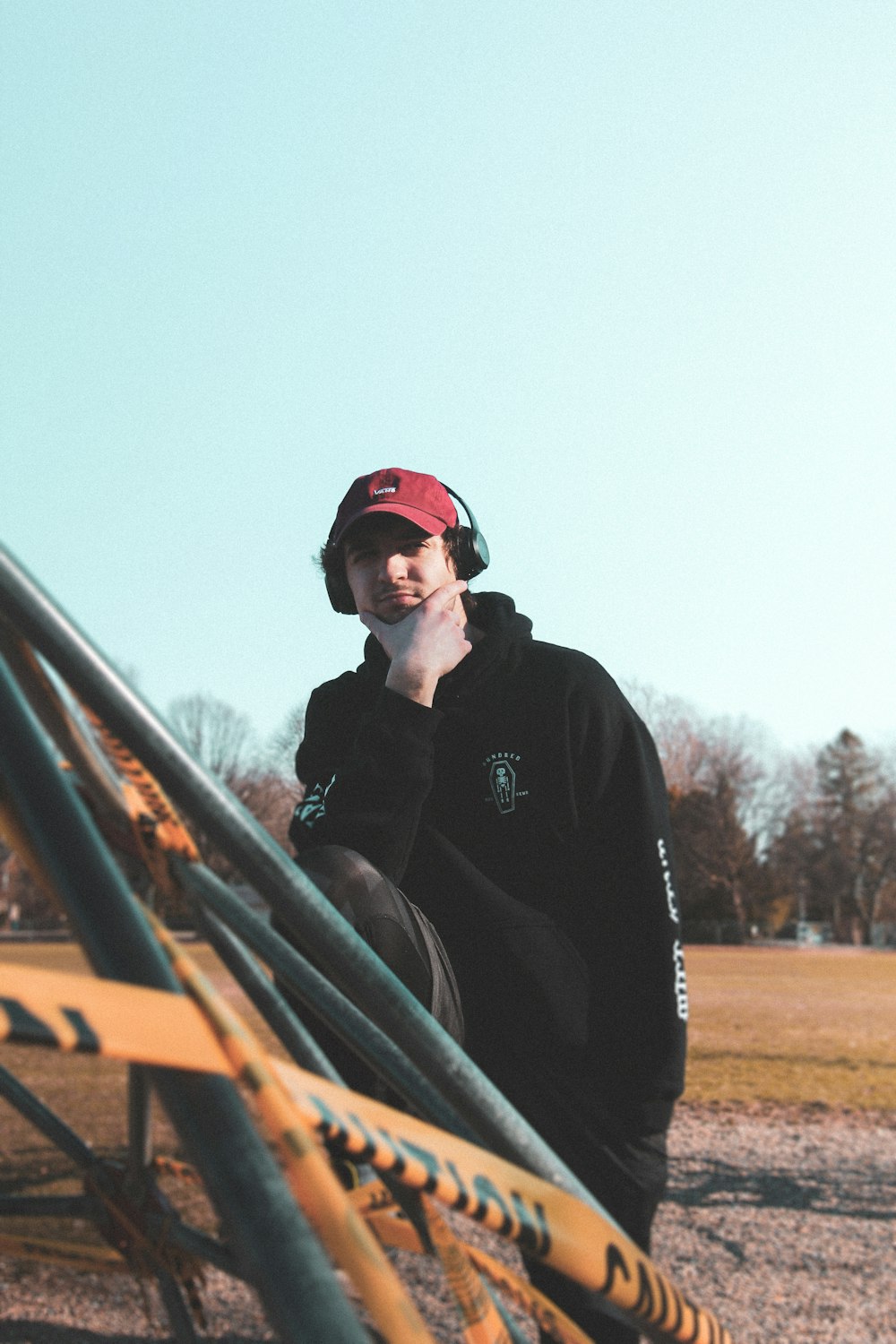 man in black jacket wearing red cap and red cap