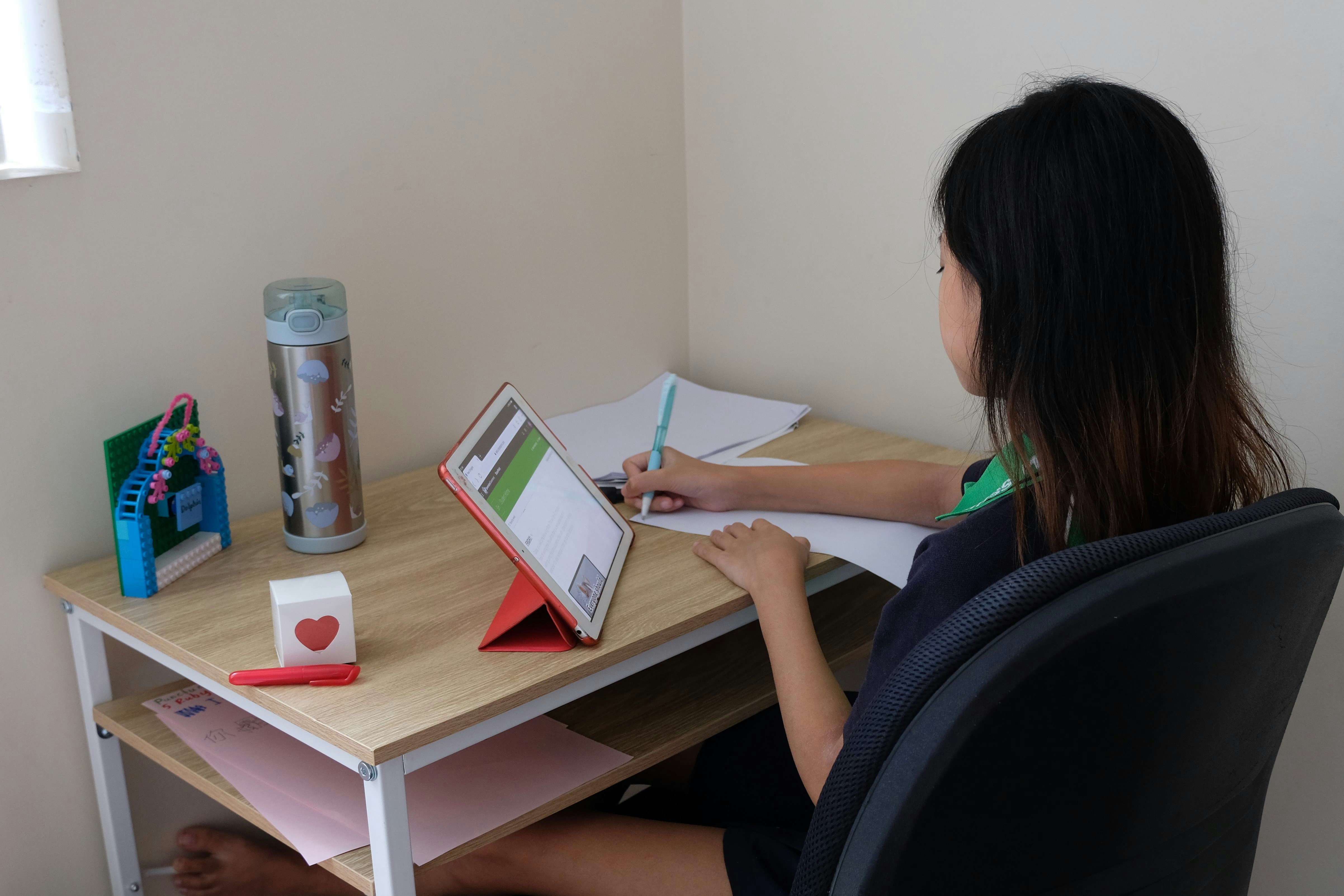 woman in green shirt sitting on black office rolling chair
