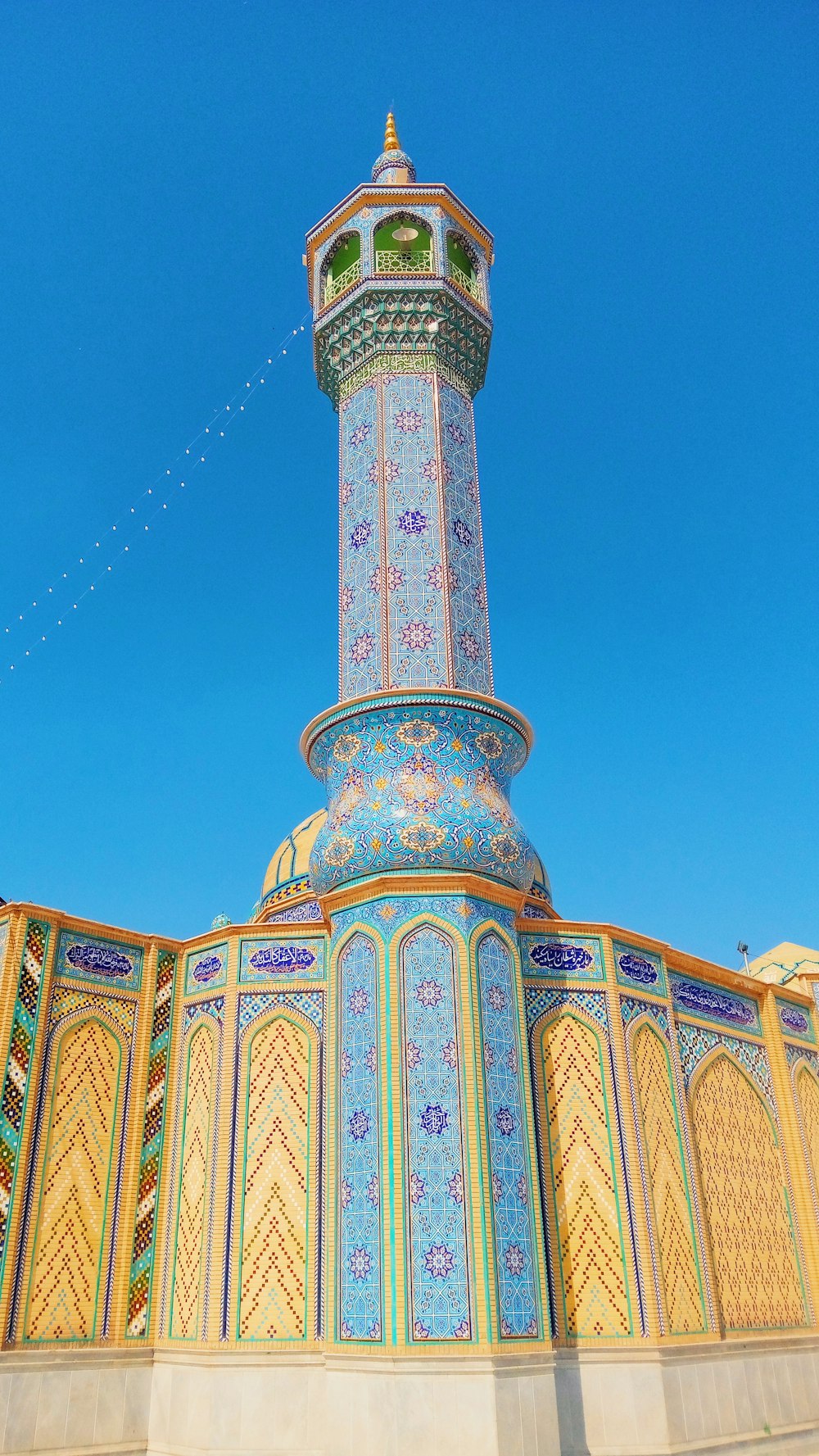 green and yellow concrete building under blue sky during daytime