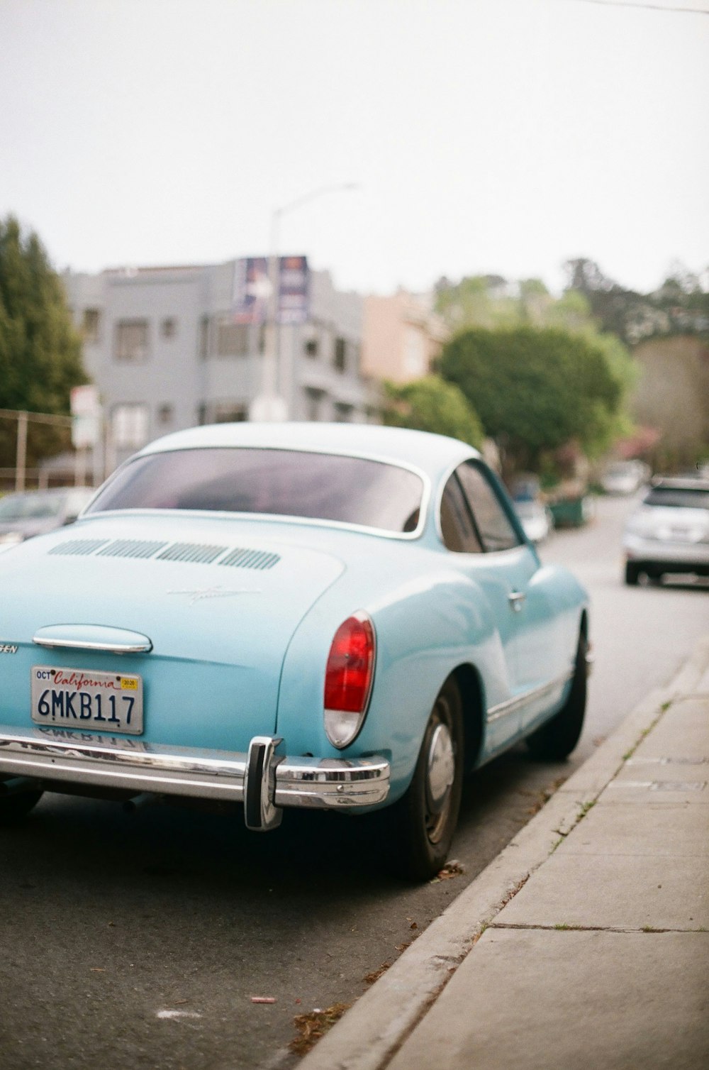 white sedan on road during daytime