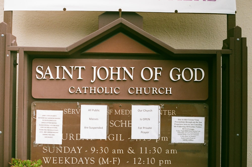 a sign for a catholic church in front of a building