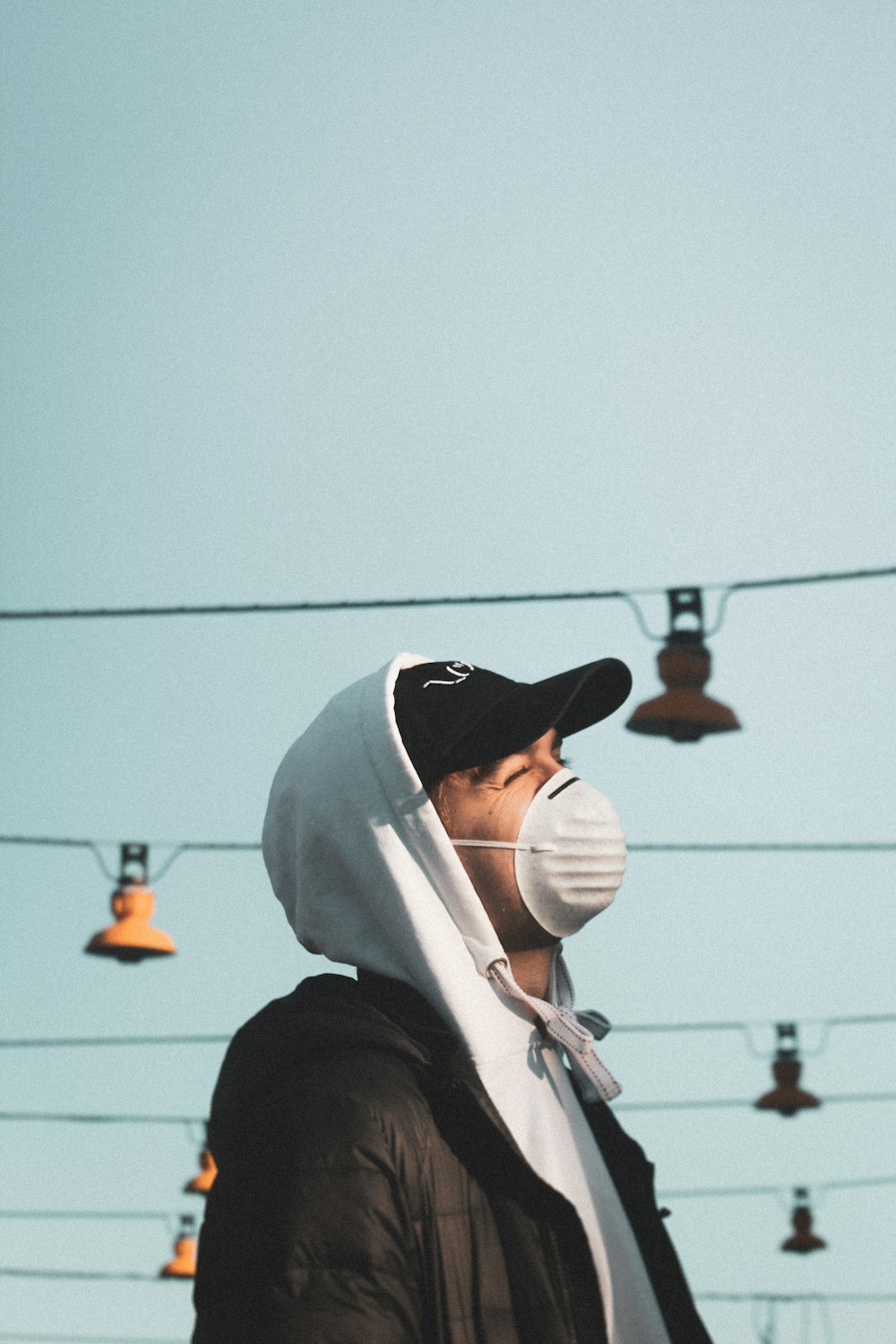 man in white hoodie wearing white hat