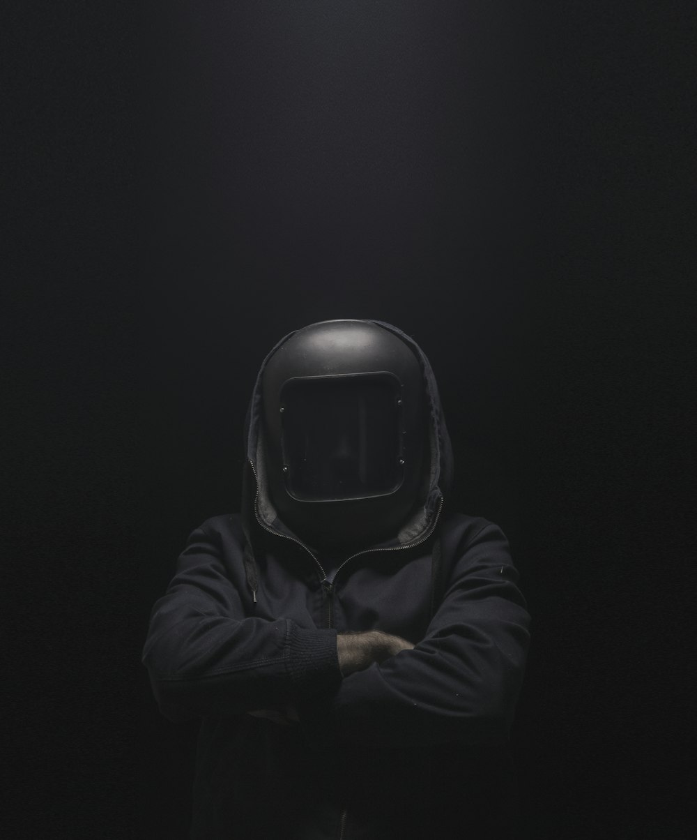 person in black hoodie wearing black helmet