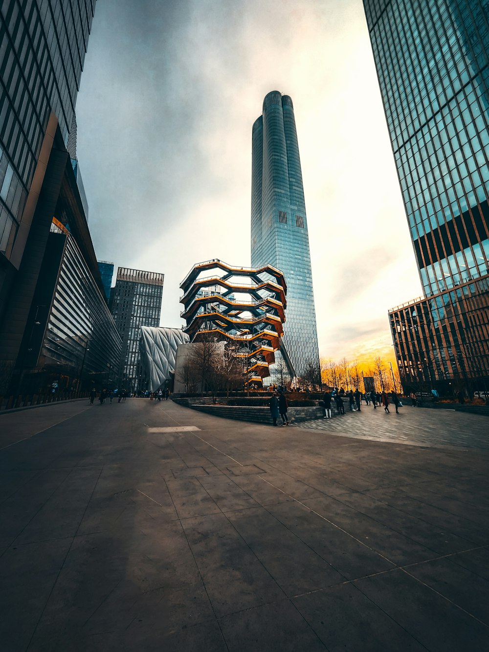 people walking on sidewalk near high rise buildings during daytime