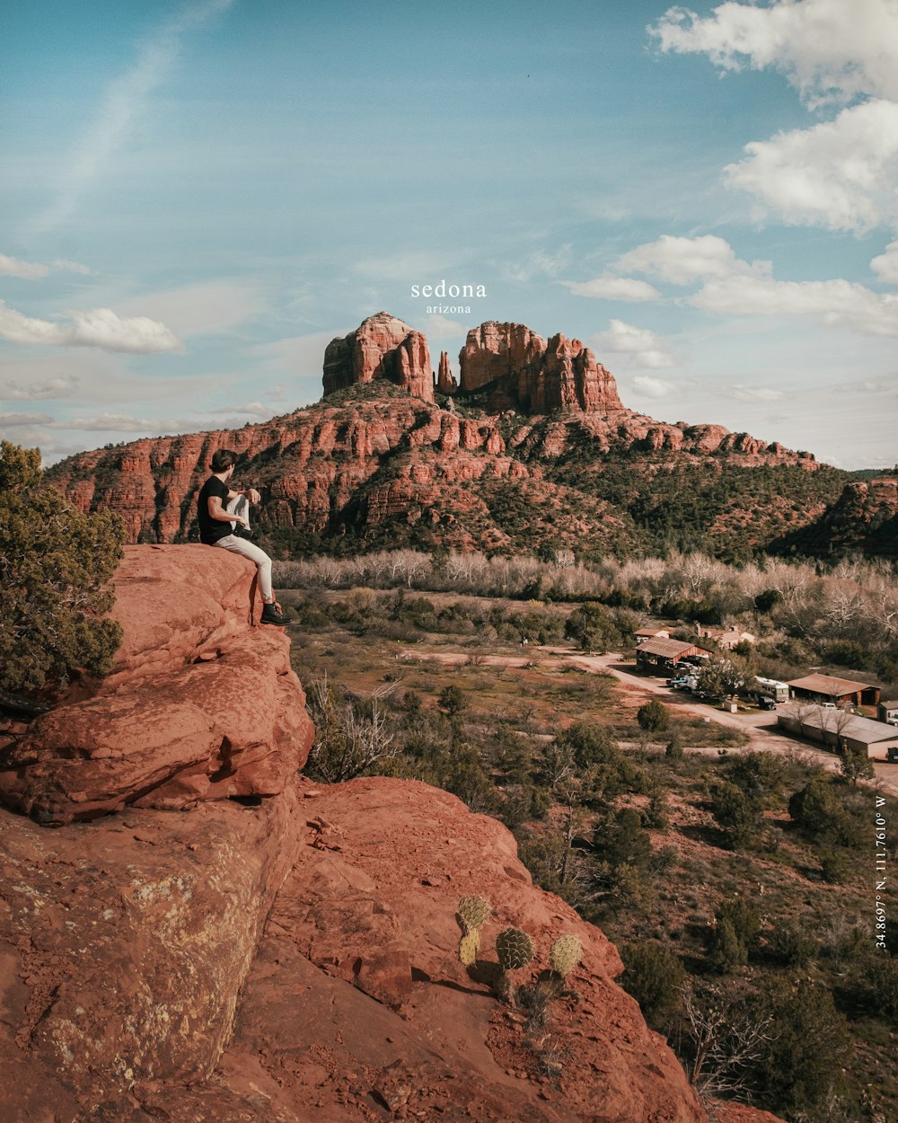 man in white shirt sitting on rock formation during daytime