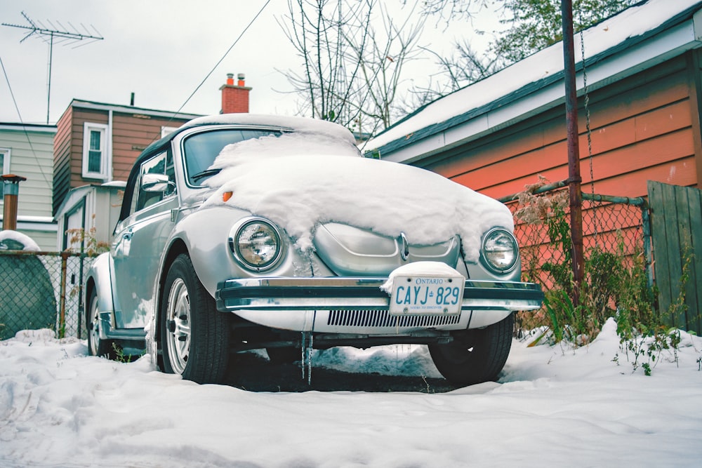 white mercedes benz car covered with snow