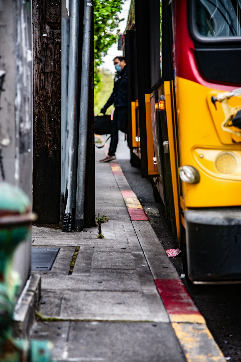 person in black jacket walking on sidewalk during daytime