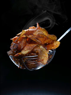 deep fried bacon in ladle 
