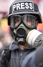 person wearing black and white gas mask