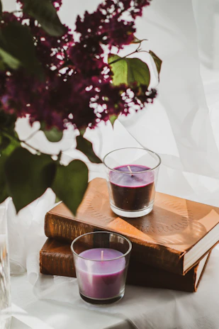 A peaceful space with purple drapes, spiritual books, and a small indoor fountain.