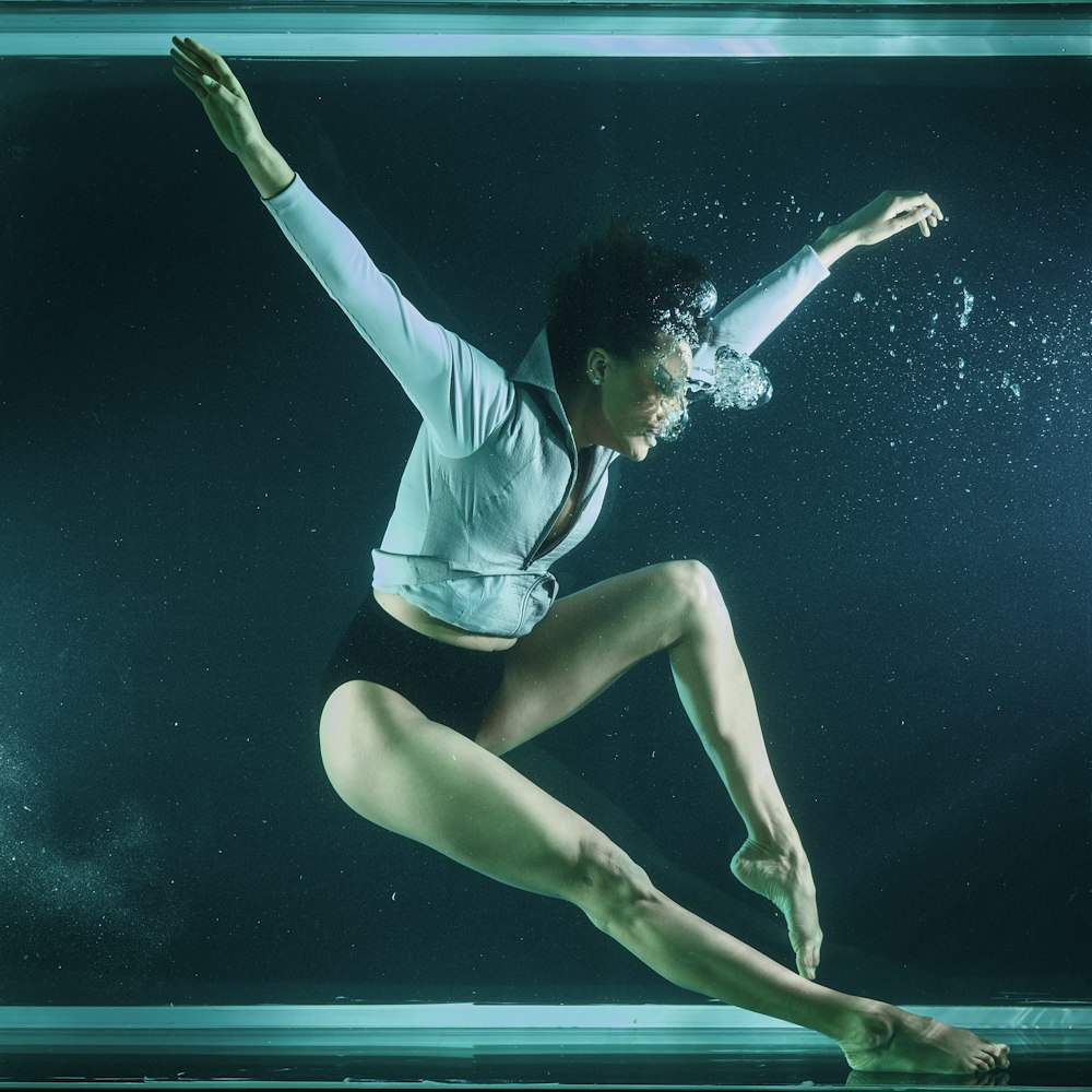 woman in blue and white shirt and blue shorts in water