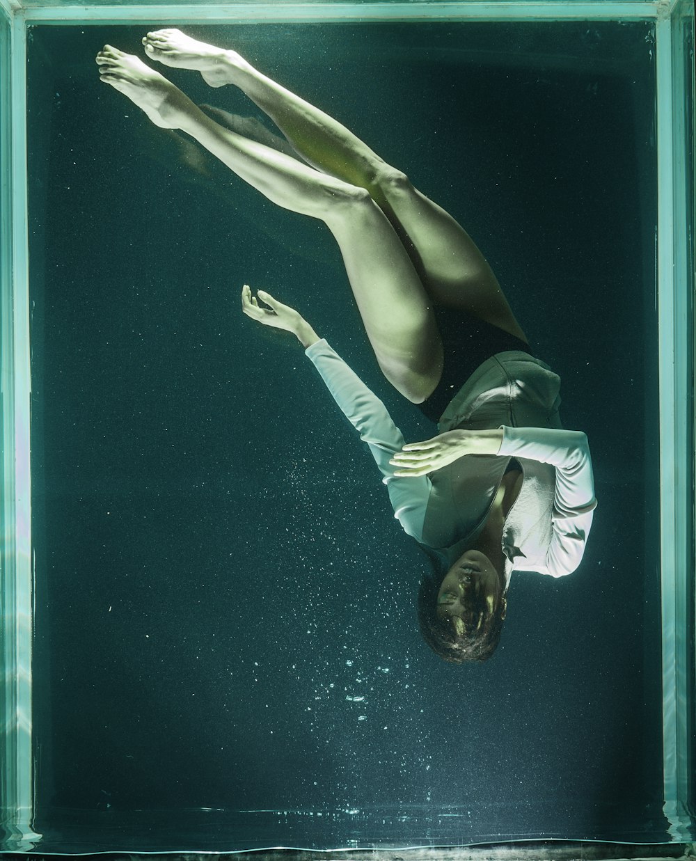 woman in white and black bikini lying on blue water