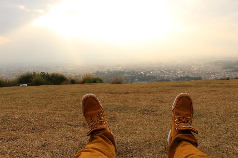 person wearing brown leather shoes