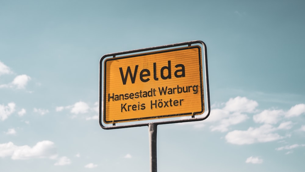 a yellow sign that says welpda on it