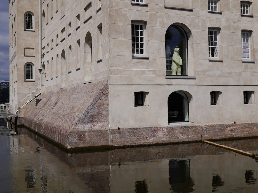 white concrete building near body of water during daytime