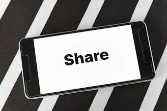 Close-up of a smartphone screen displaying empowering digital downloads from Share Tha Word.