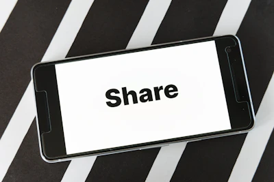 Close-up of a smartphone screen displaying empowering digital downloads from Share Tha Word.
