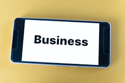 An alert notification popping up on a smartphone screen showing a business mention.