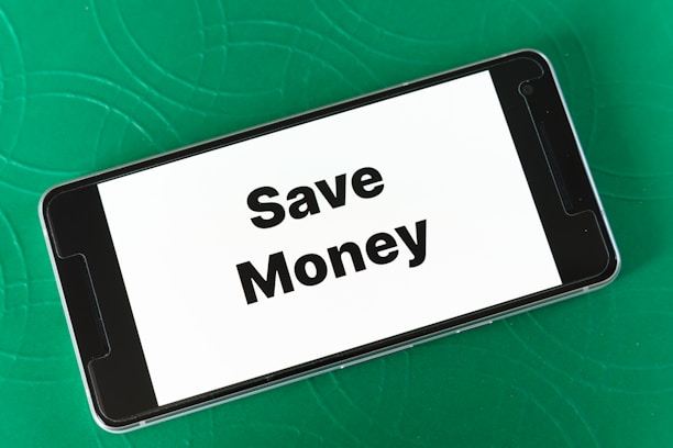 A smartphone displaying a discount coupon on a vibrant background.