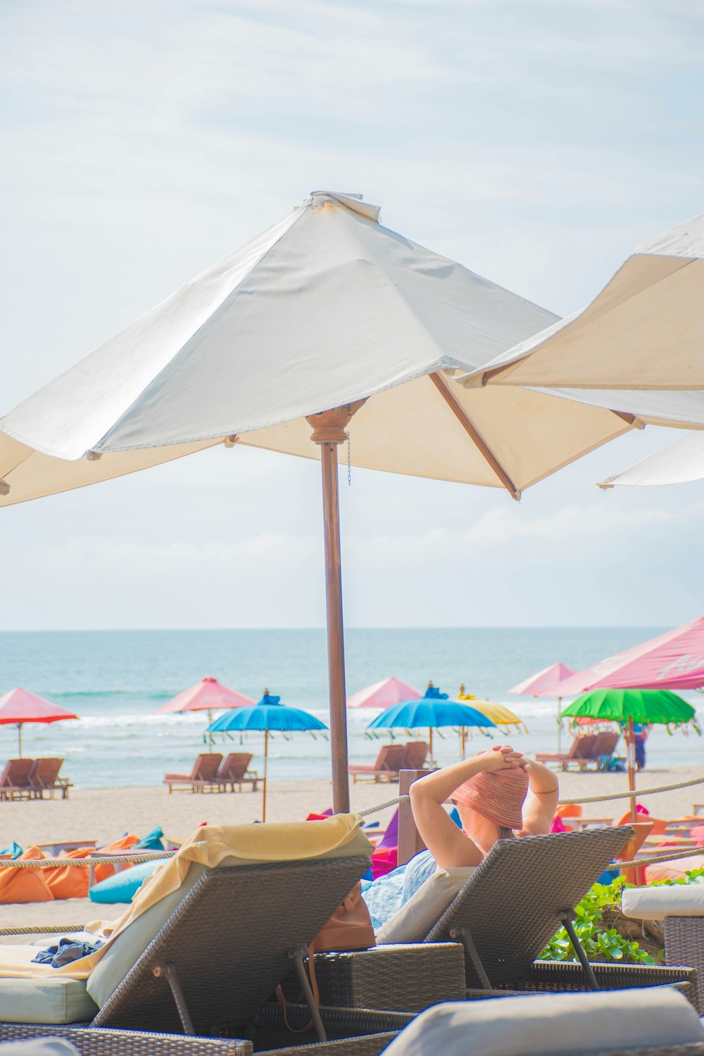 woman in blue bikini lying on yellow sun lounger on beach during daytime